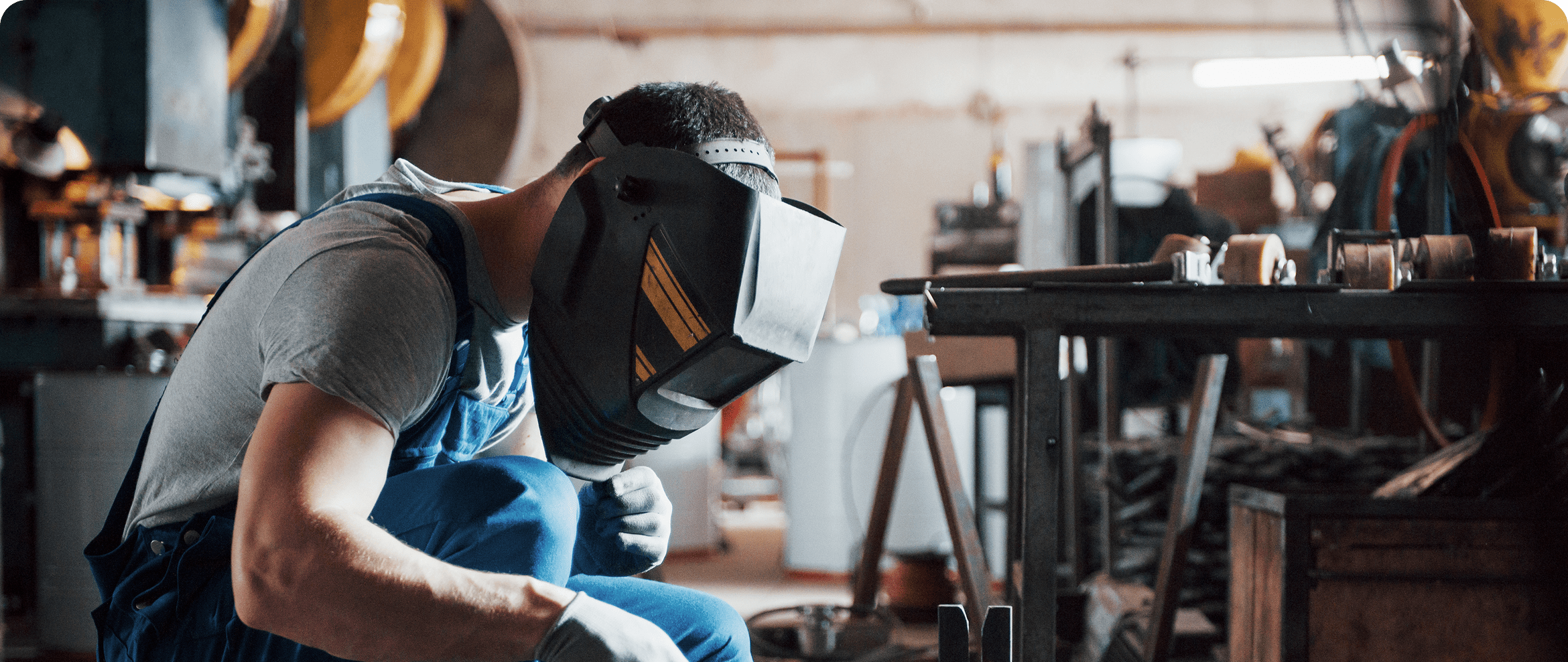 Welder working on automobile parts